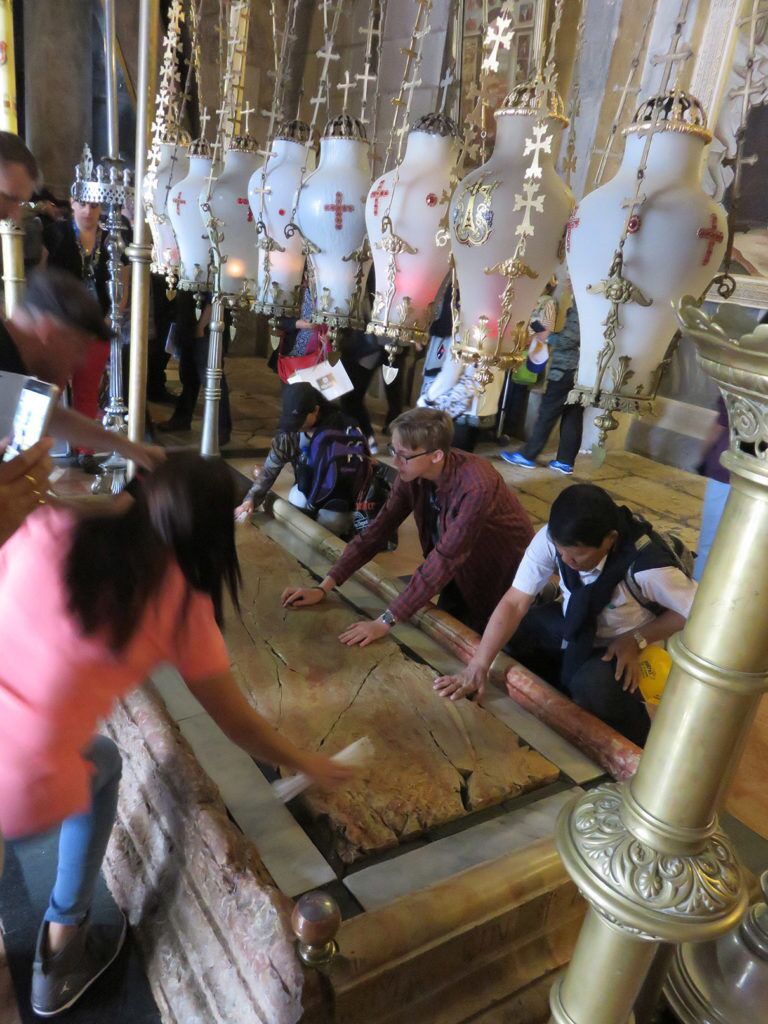 14 Veneration of Stone PILGRIMS VENERATING the stone of anointing